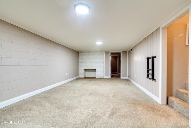unfurnished living room featuring a large fireplace, baseboards, carpet flooring, and stairs