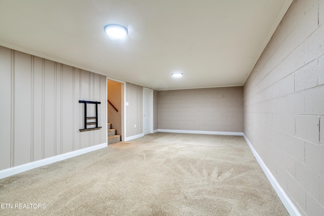 finished below grade area featuring carpet and stairs