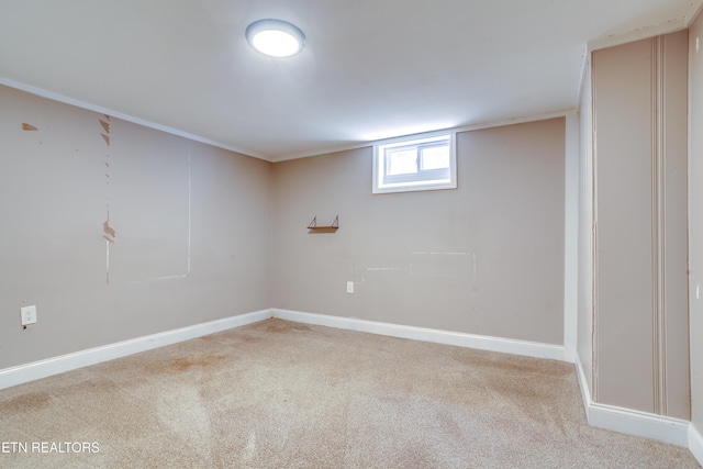 below grade area featuring carpet and baseboards