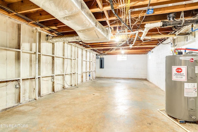 basement featuring water heater and electric panel