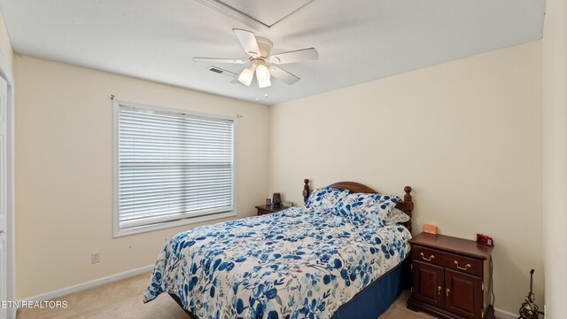 bedroom featuring baseboards, ceiling fan, light carpet, and visible vents
