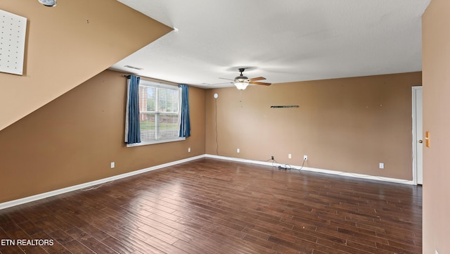spare room with baseboards, ceiling fan, wood finished floors, and visible vents