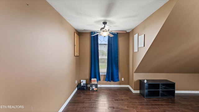 interior space with baseboards, a ceiling fan, and wood finished floors