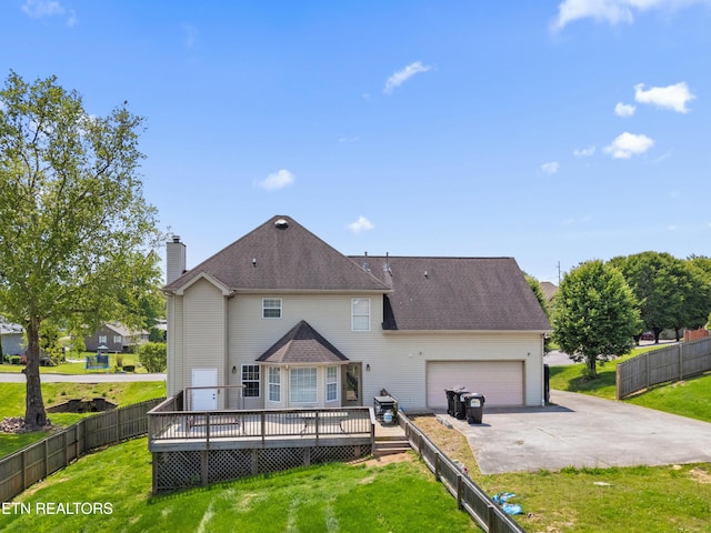back of house with a garage, a wooden deck, a chimney, a lawn, and driveway