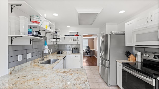 kitchen with open shelves, light stone countertops, white cabinetry, a sink, and appliances with stainless steel finishes