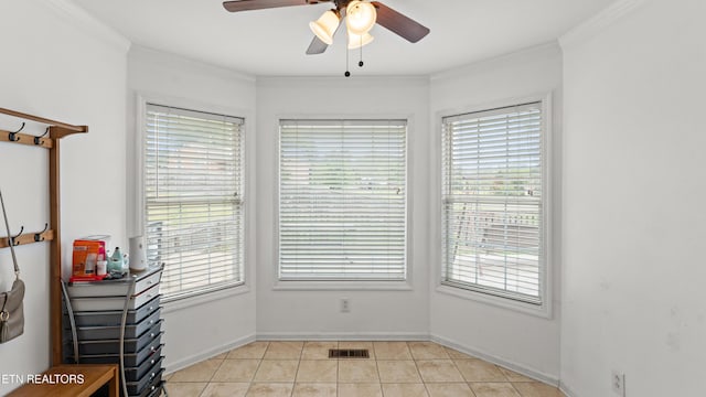 interior space featuring crown molding, a wealth of natural light, a ceiling fan, and visible vents