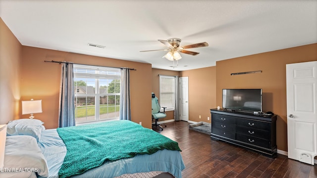 bedroom featuring baseboards, ceiling fan, dark wood-type flooring, and visible vents