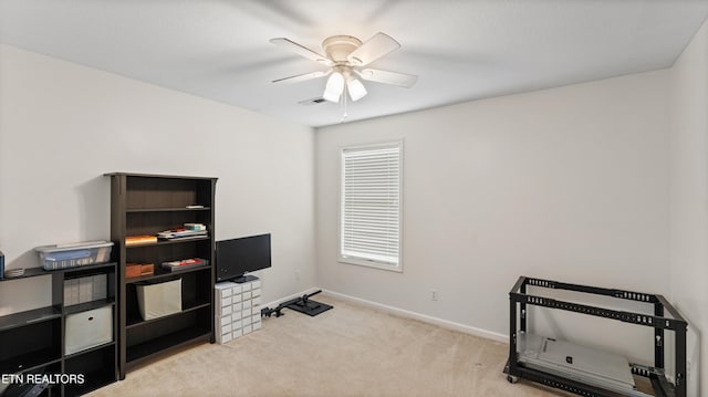interior space featuring baseboards, carpet flooring, ceiling fan, and visible vents