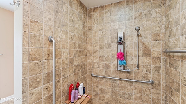 bathroom with tiled shower