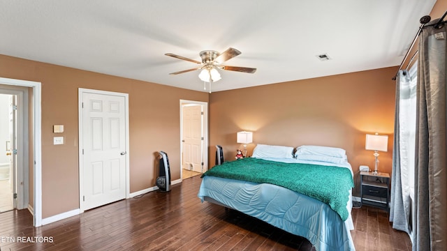 bedroom featuring visible vents, a ceiling fan, baseboards, and wood finished floors
