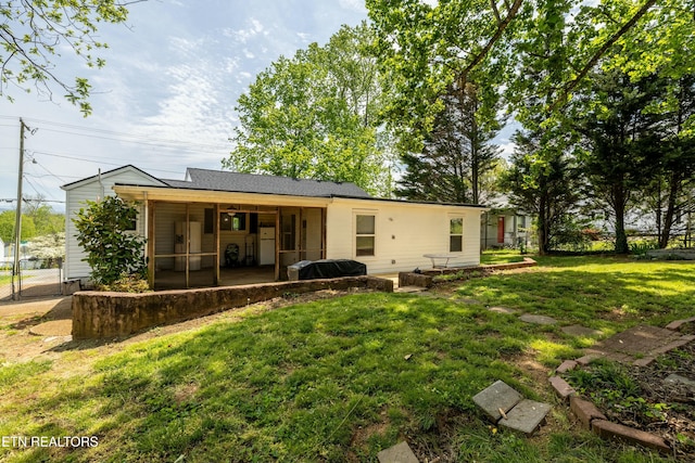 back of house with a gate, fence, a patio, a sunroom, and a lawn