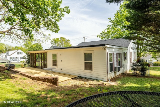 back of house featuring fence, a yard, a patio, and a shingled roof