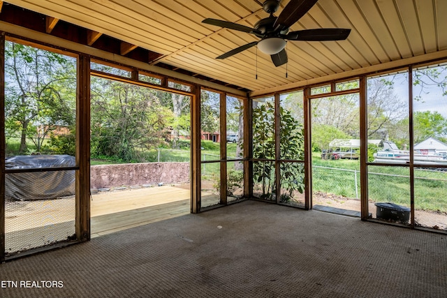 unfurnished sunroom featuring ceiling fan