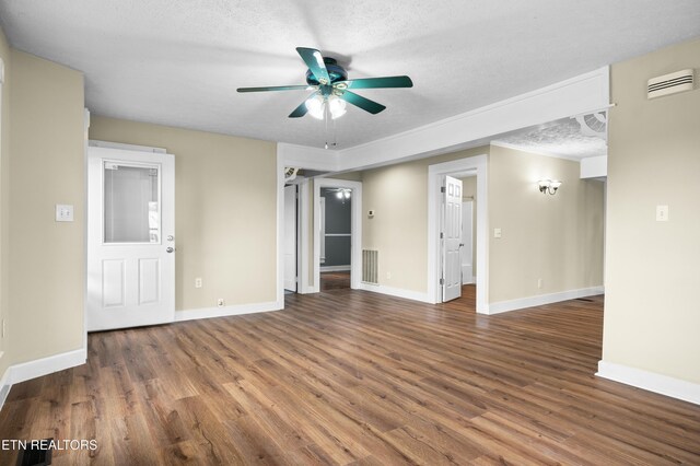 spare room featuring visible vents, ceiling fan, wood finished floors, and baseboards