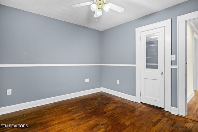 unfurnished room with wood finished floors, ceiling fan, and baseboards