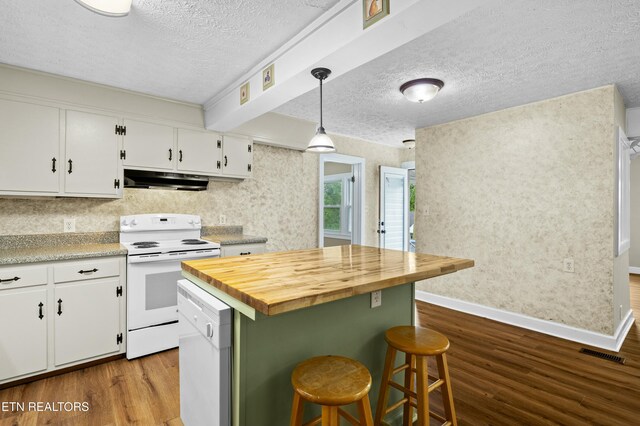 kitchen with a textured ceiling, visible vents, white appliances, and dark wood-style floors
