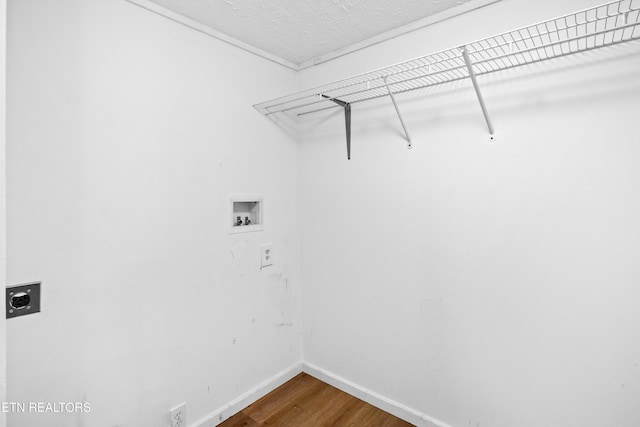 laundry room featuring hookup for a washing machine, wood finished floors, laundry area, electric dryer hookup, and baseboards