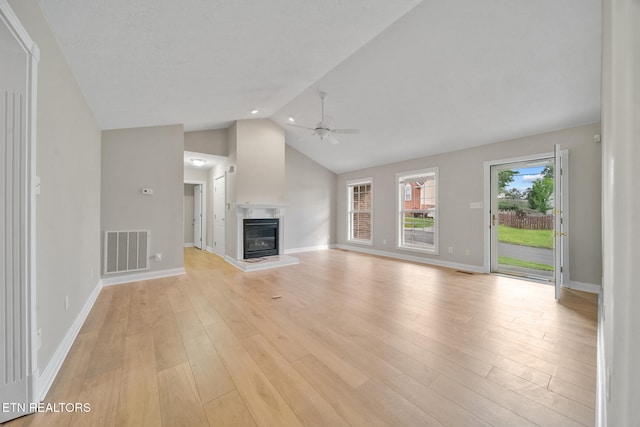 4762 Cabbage Ln, Knoxville, TN 37938 - unfurnished living room with light wood-style floors, a premium fireplace, visible vents, a ceiling fan, and lofted ceiling