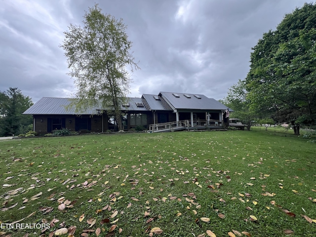exterior space featuring a yard and metal roof