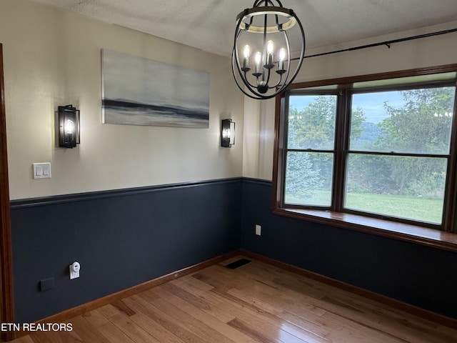 391 Underwood Grove Rd, Cumberland Gap, TN 37724 - unfurnished room with a chandelier and wood finished floors