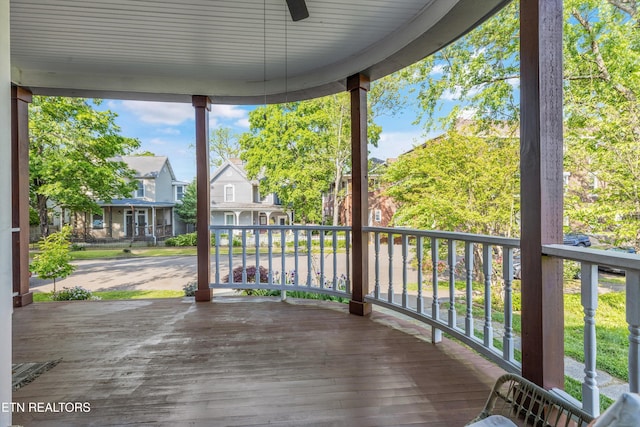 deck featuring ceiling fan and a residential view