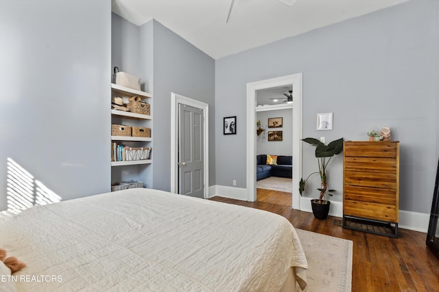 bedroom with baseboards, a ceiling fan, and dark wood-style flooring