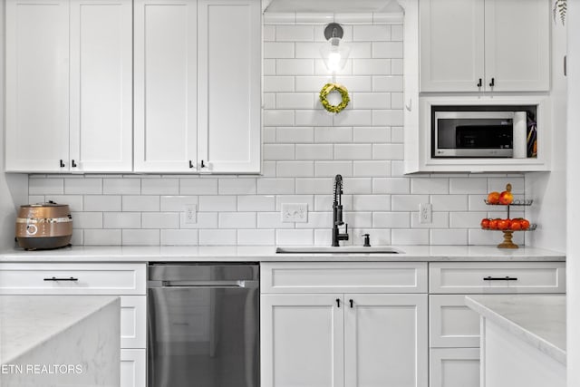kitchen featuring white cabinets, stainless steel appliances, and a sink