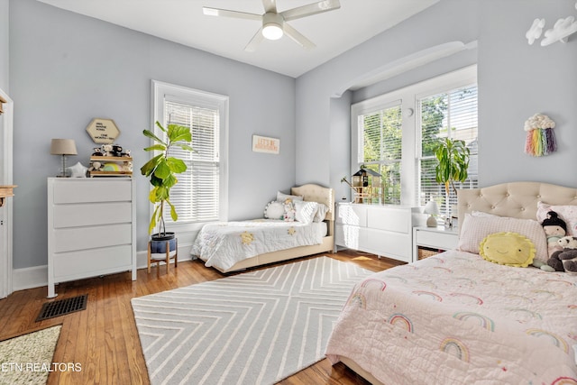 bedroom featuring visible vents, wood-type flooring, and ceiling fan