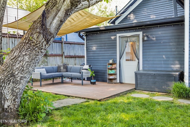 view of outdoor structure with fence and an outdoor hangout area