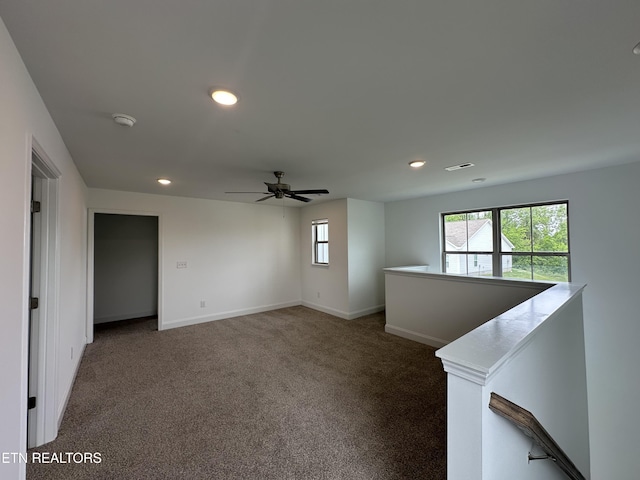 unfurnished room with baseboards, dark colored carpet, ceiling fan, and recessed lighting