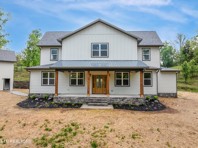 view of front of property featuring a porch, board and batten siding, and metal roof