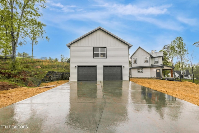 exterior space featuring driveway, board and batten siding, and a garage