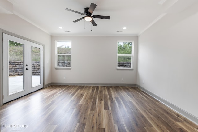 empty room featuring a healthy amount of sunlight, french doors, and crown molding