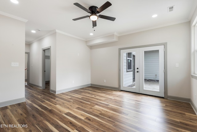empty room featuring crown molding, recessed lighting, wood finished floors, and french doors