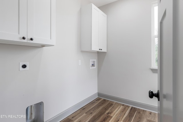 laundry room with hookup for an electric dryer, washer hookup, baseboards, cabinet space, and dark wood-type flooring