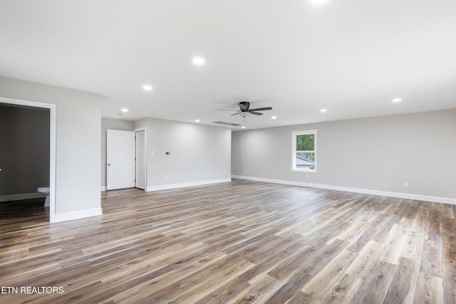 unfurnished living room with recessed lighting, a ceiling fan, wood finished floors, and baseboards