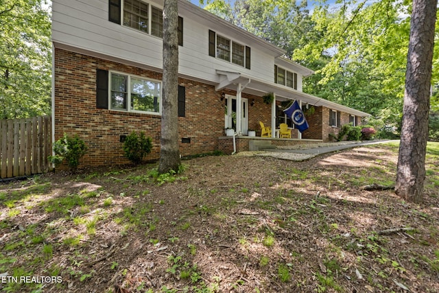 705 Kimbee Rd, Knoxville, TN 37923 - view of front facade featuring a porch, brick siding, fence, and crawl space