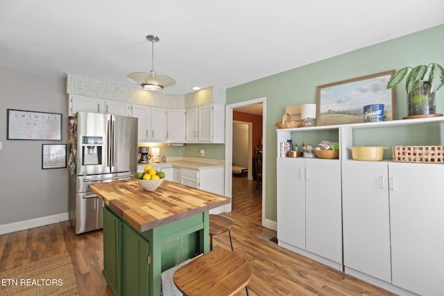 705 Kimbee Rd, Knoxville, TN 37923 - kitchen with wooden counters, baseboards, stainless steel refrigerator with ice dispenser, dark wood-style floors, and green cabinets