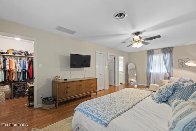 705 Kimbee Rd, Knoxville, TN 37923 - bedroom featuring a walk in closet, baseboards, dark wood-type flooring, and visible vents
