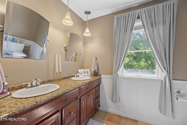 705 Kimbee Rd, Knoxville, TN 37923 - bathroom featuring double vanity, a sink, tile patterned flooring, and a wainscoted wall