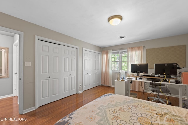 705 Kimbee Rd, Knoxville, TN 37923 - bedroom with visible vents, baseboards, multiple closets, and wood finished floors