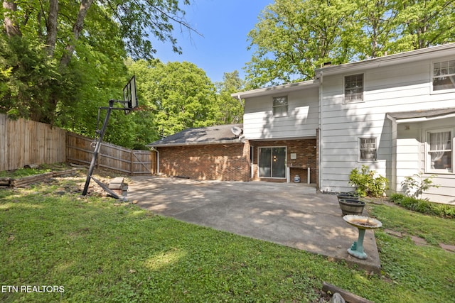 705 Kimbee Rd, Knoxville, TN 37923 - back of property featuring a yard, brick siding, fence, and a patio