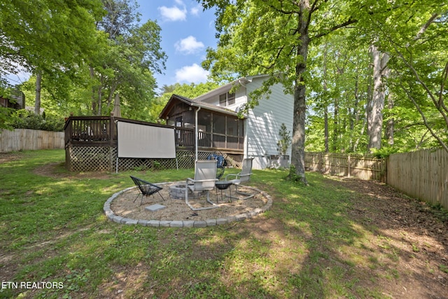 705 Kimbee Rd, Knoxville, TN 37923 - view of yard featuring a fenced backyard, a sunroom, a fire pit, and a deck