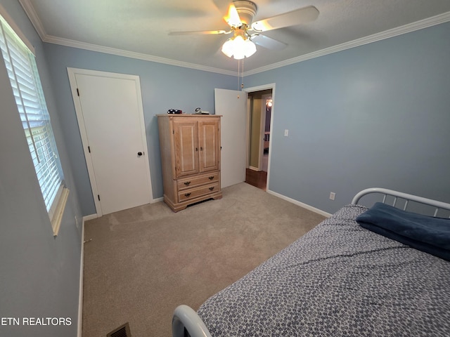 bedroom featuring crown molding, a ceiling fan, light colored carpet, and visible vents