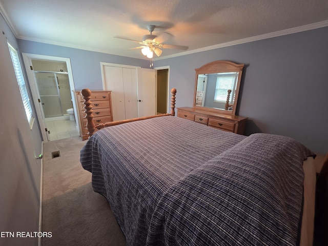 bedroom with a ceiling fan, visible vents, crown molding, a closet, and carpet flooring