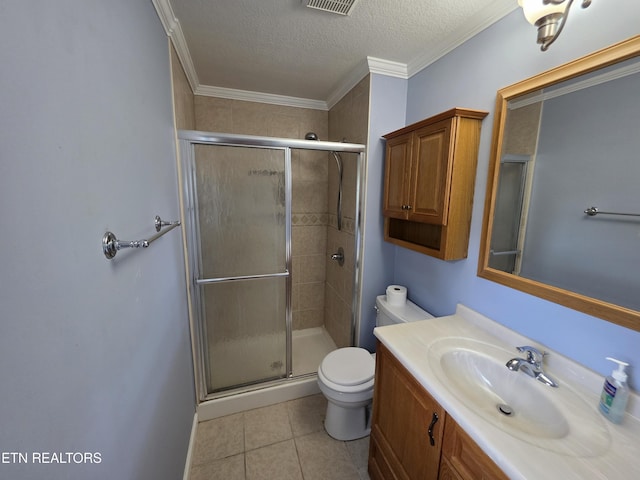 bathroom featuring a textured ceiling, tile patterned flooring, a stall shower, vanity, and toilet