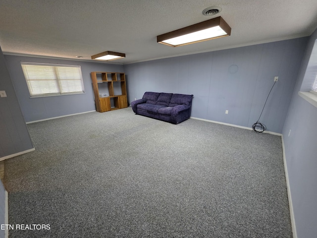 unfurnished room featuring carpet floors, a textured ceiling, and visible vents