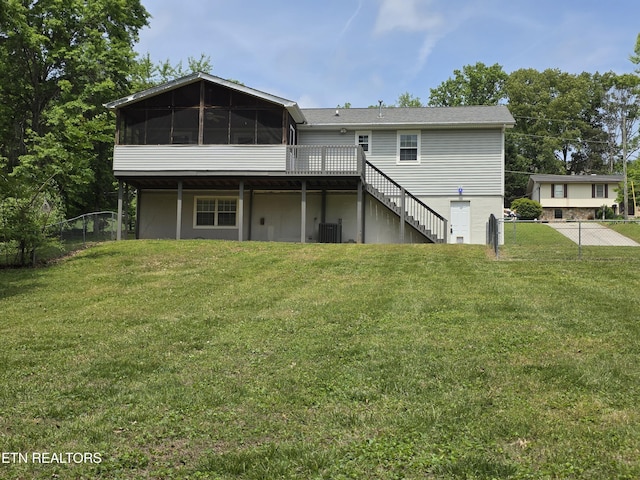 back of property with a wooden deck, cooling unit, a sunroom, a yard, and stairway