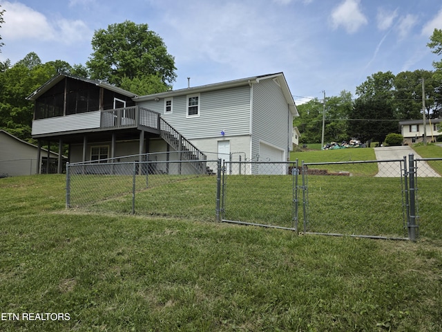 rear view of house with a gate, a sunroom, stairway, fence, and an attached garage