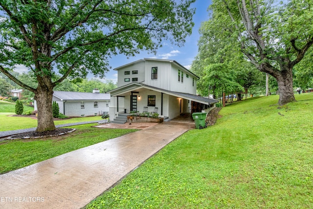 view of front of house featuring concrete driveway, a porch, and a front yard